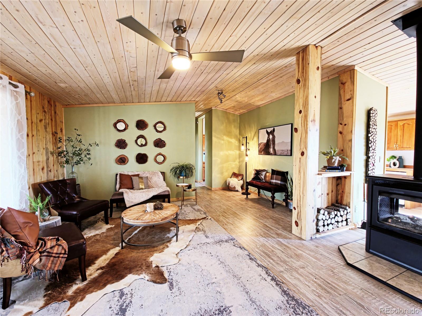 891 South Mountain Estates Road Florissant, CO 80816 - Photo 2 of 43 a living room with furniture and wooden floor