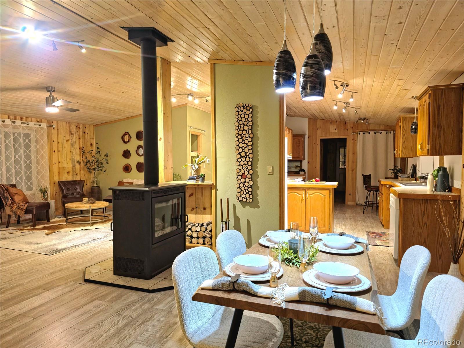 891 South Mountain Estates Road Florissant, CO 80816 - Photo 3 of 43 a view of a dining room with furniture window and wooden floor
