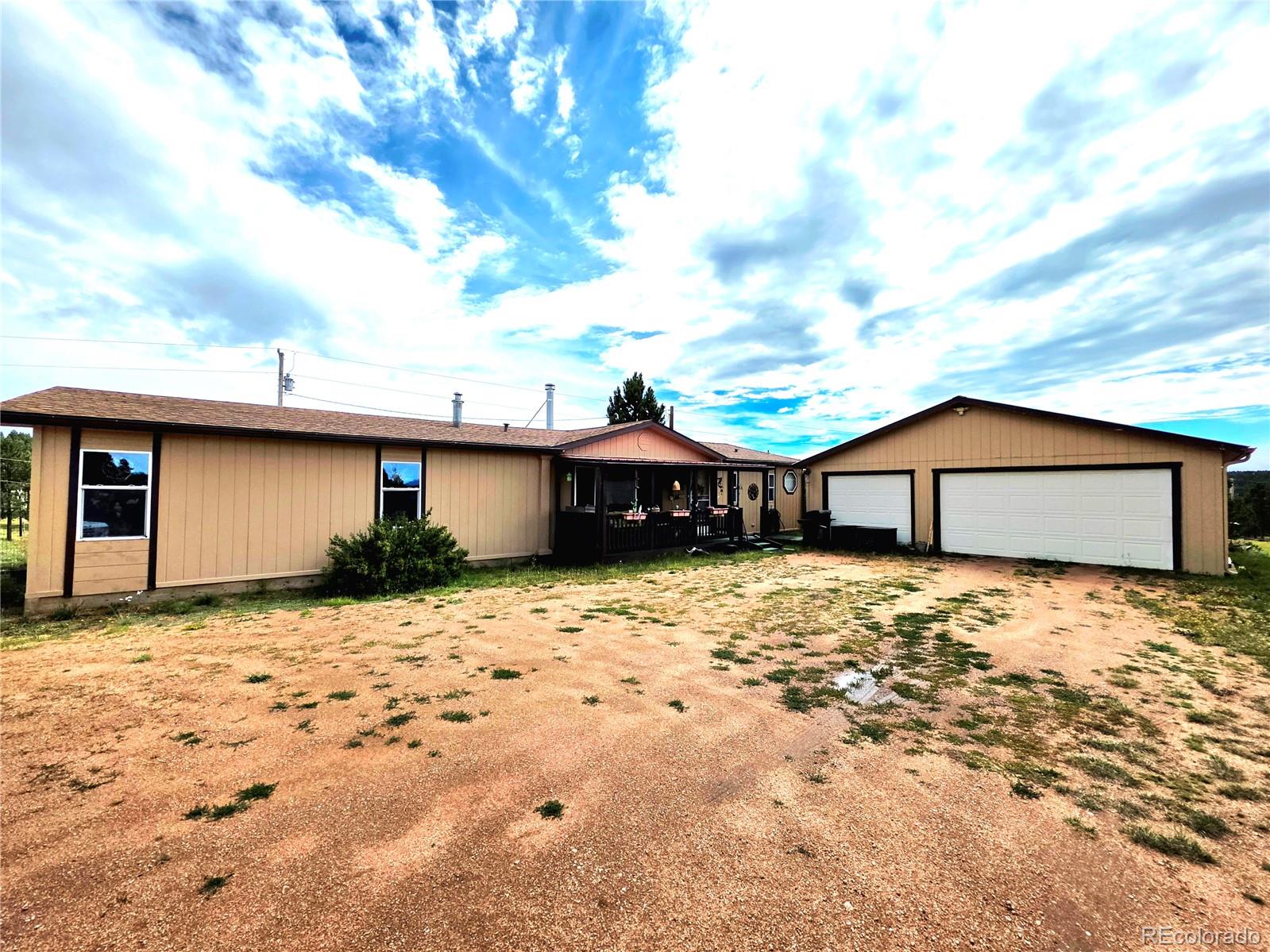 891 South Mountain Estates Road Florissant, CO 80816 - Photo 37 of 43 a front view of a house with a yard
