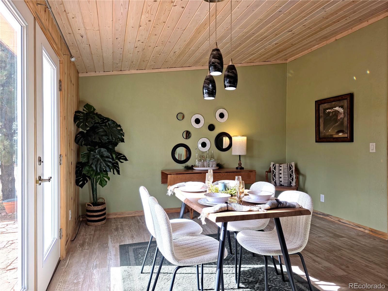 891 South Mountain Estates Road Florissant, CO 80816 - Photo 5 of 43 a view of a dining room with furniture and wooden floor