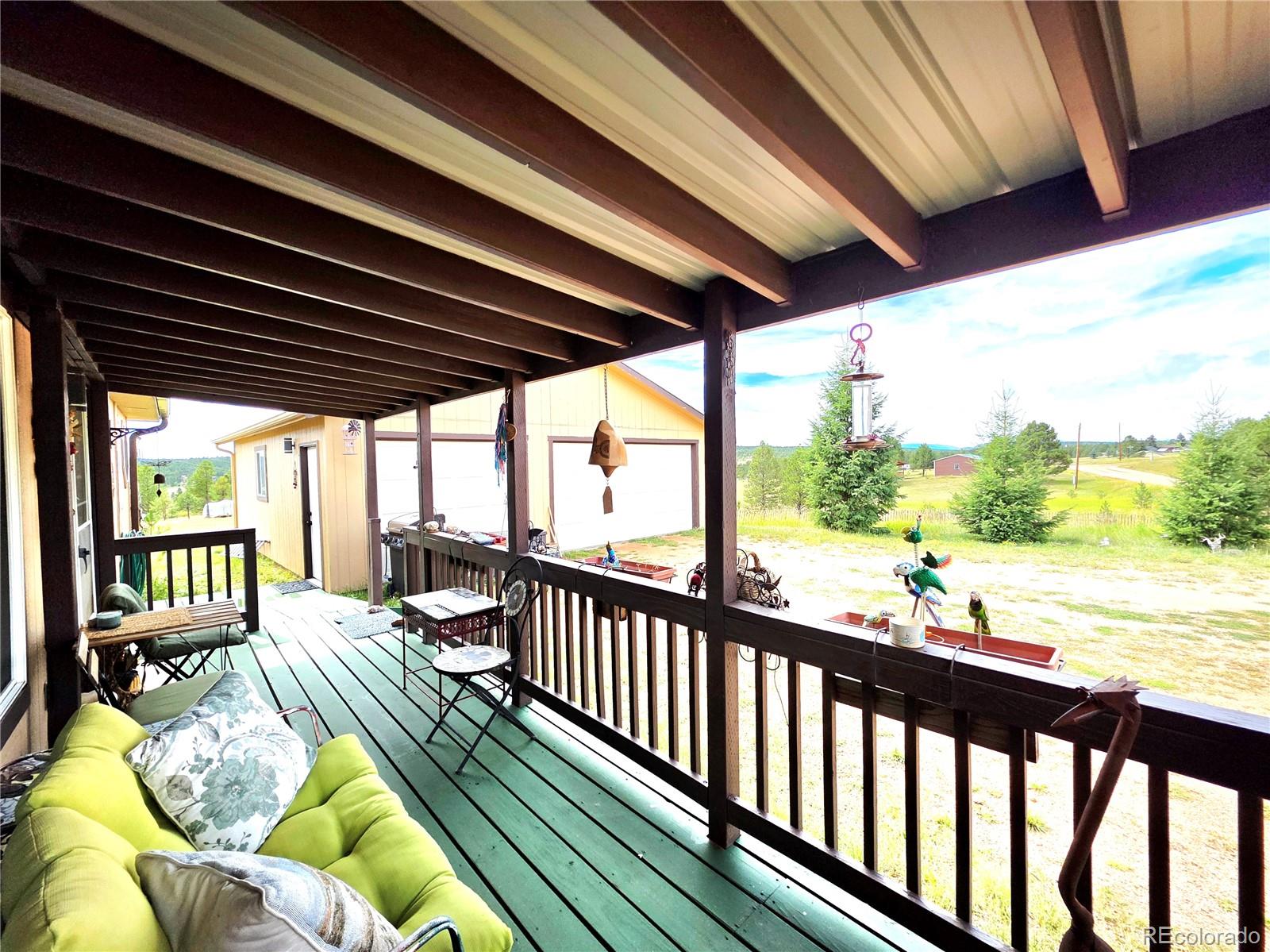891 South Mountain Estates Road Florissant, CO 80816 - Photo 6 of 43 a view of balcony with couch and wooden floor