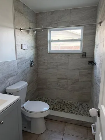 a bathroom with a toilet and shower