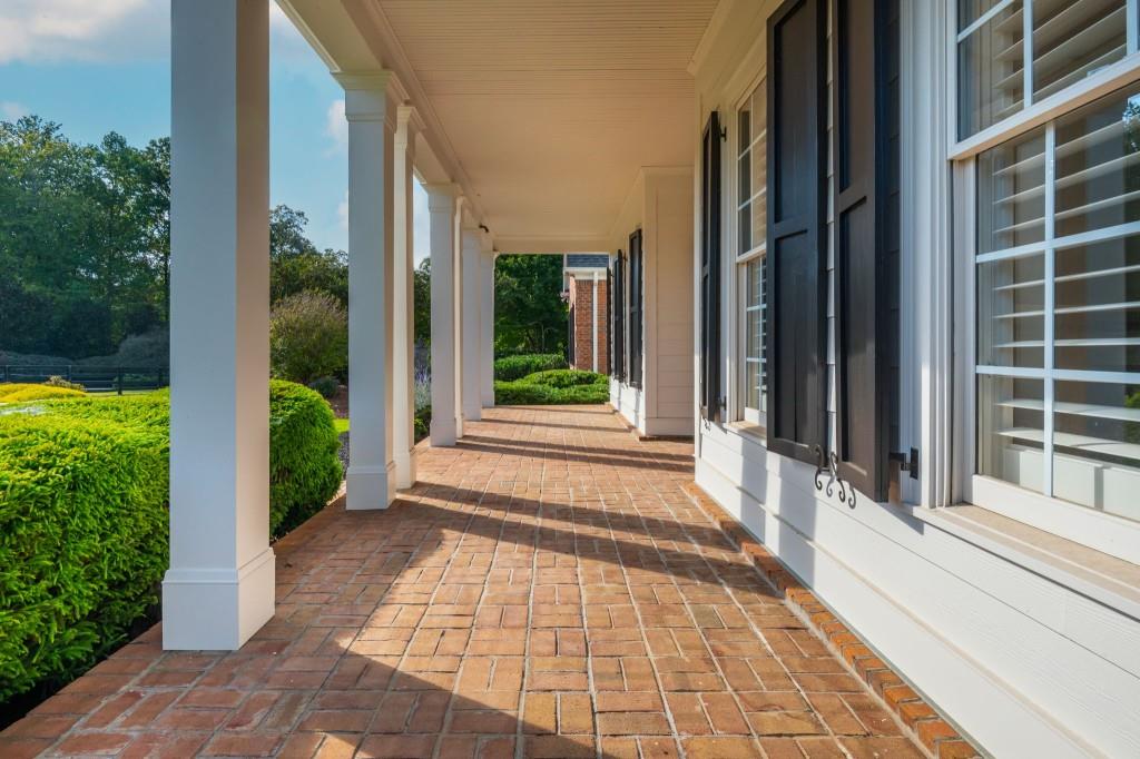 220 Edwards Brook Court Canton, GA 30115 - Photo 13 of 77 a view of a house with potted plants and floor to ceiling windows