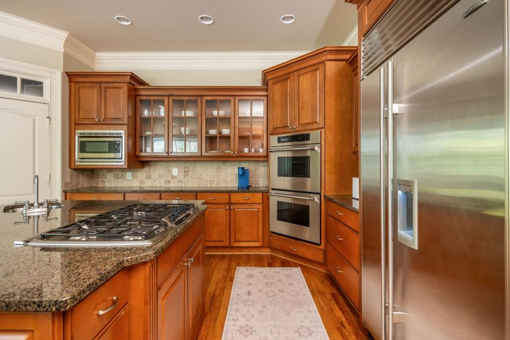 220 Edwards Brook Court Canton, GA 30115 - Photo 28 of 77 a kitchen with stainless steel appliances granite countertop a refrigerator and a stove top oven