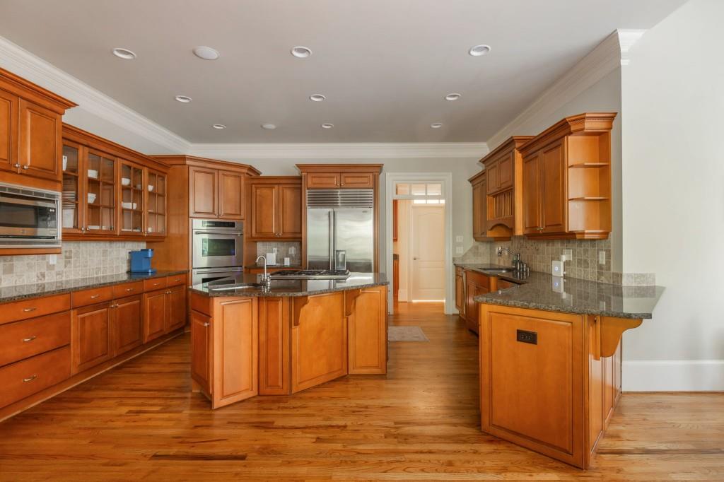 220 Edwards Brook Court Canton, GA 30115 - Photo 30 of 77 a large kitchen with stainless steel appliances granite countertop a stove and a sink