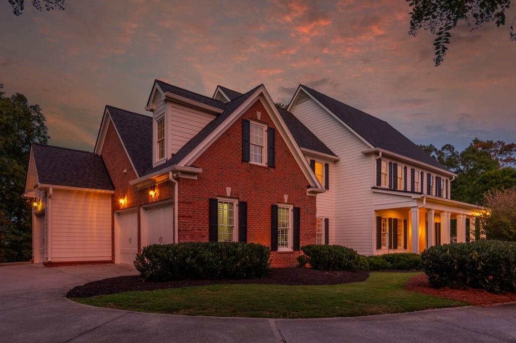 220 Edwards Brook Court Canton, GA 30115 - Photo 4 of 77 a front view of a house with garden