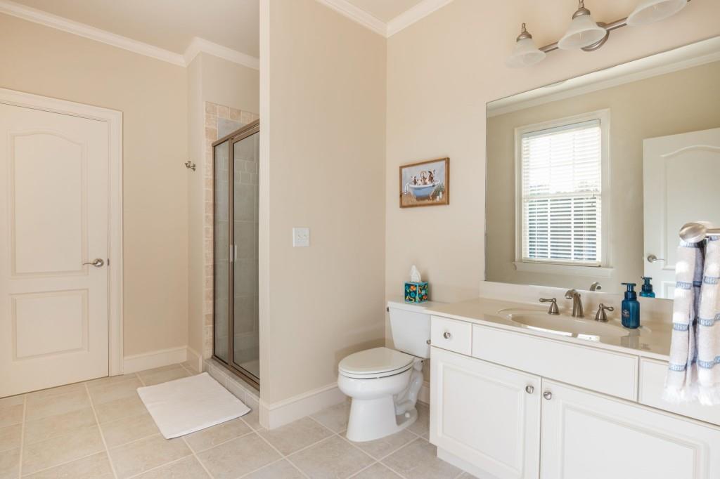 220 Edwards Brook Court Canton, GA 30115 - Photo 43 of 77 a spacious bathroom with a granite countertop sink a toilet and a mirror