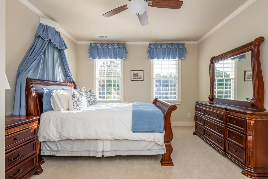 220 Edwards Brook Court Canton, GA 30115 - Photo 50 of 77 a bedroom with a bed and a dresser