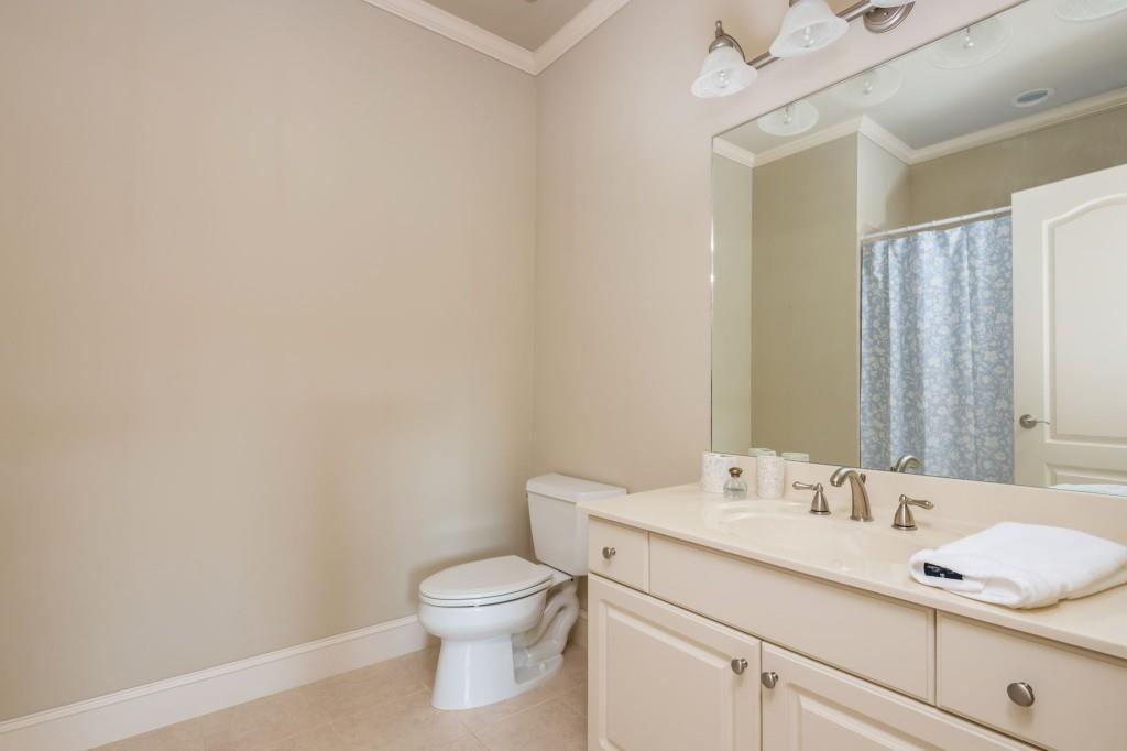 220 Edwards Brook Court Canton, GA 30115 - Photo 51 of 77 a bathroom with a granite countertop sink a toilet and a mirror