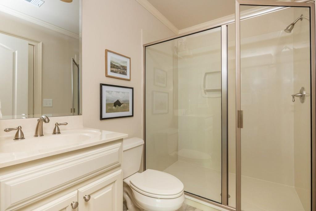 220 Edwards Brook Court Canton, GA 30115 - Photo 60 of 77 a bathroom with a shower sink vanity mirror and toilet