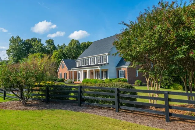 a view of a house with a yard and sitting area