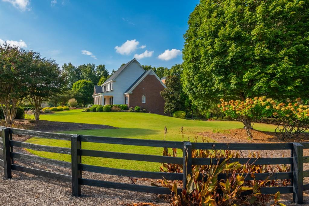 220 Edwards Brook Court Canton, GA 30115 - Photo 10 of 77 a view of a house with a yard and sitting area