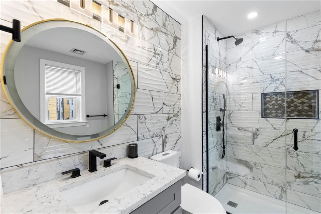 77 Cedar Street Boston, MA 02119 - Photo 17 of 25 a bathroom with a sink a toilet and shower