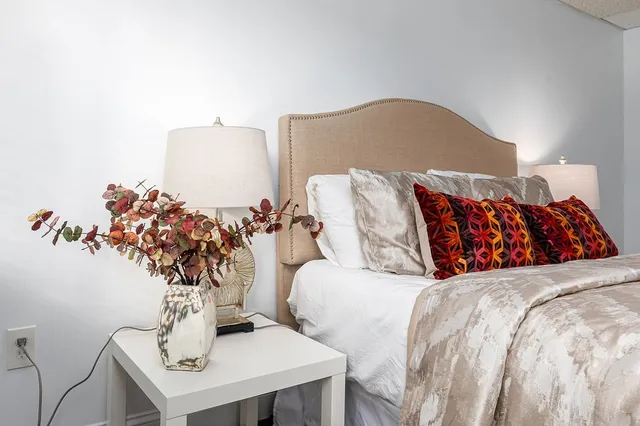 a view of a bedroom with a bed and a window