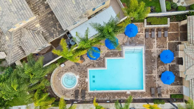 an aerial view of a house with yard swimming pool and lake view