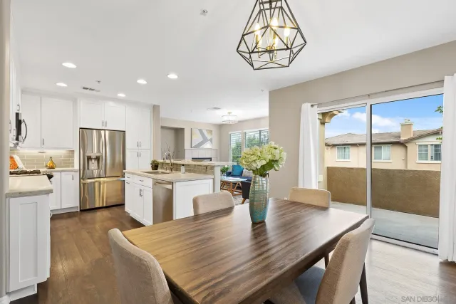 a kitchen with white cabinets sink and stainless steel appliances