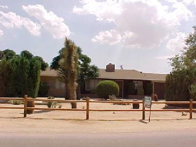 a view of swimming pool with outdoor seating and house in the background