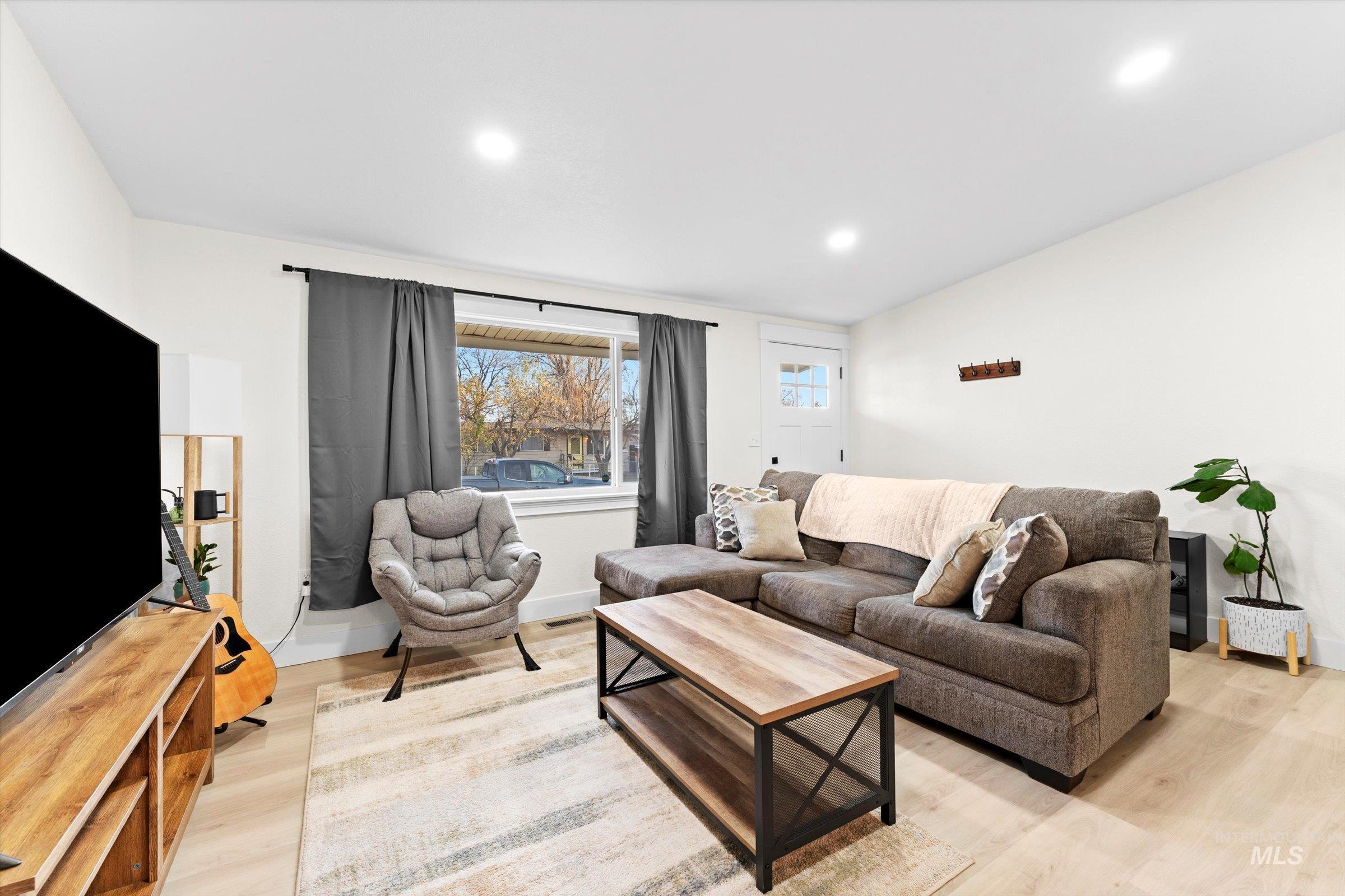 406 Chestnut Street Mountain Home, ID 83647 - Photo 17 of 31 Living room featuring light wood finished floors and recessed lighting