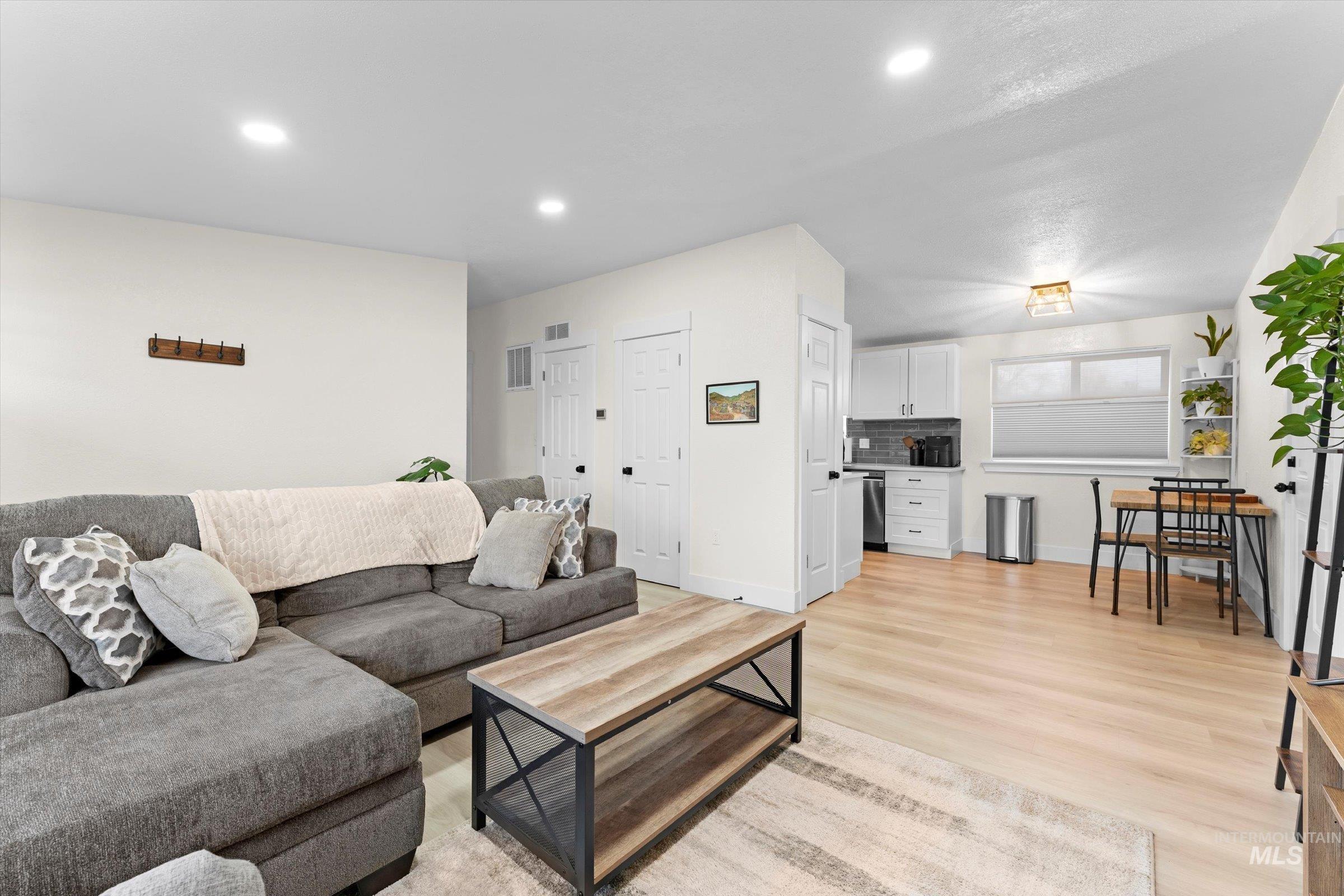 406 Chestnut Street Mountain Home, ID 83647 - Photo 18 of 31 Living room with light wood finished floors and recessed lighting