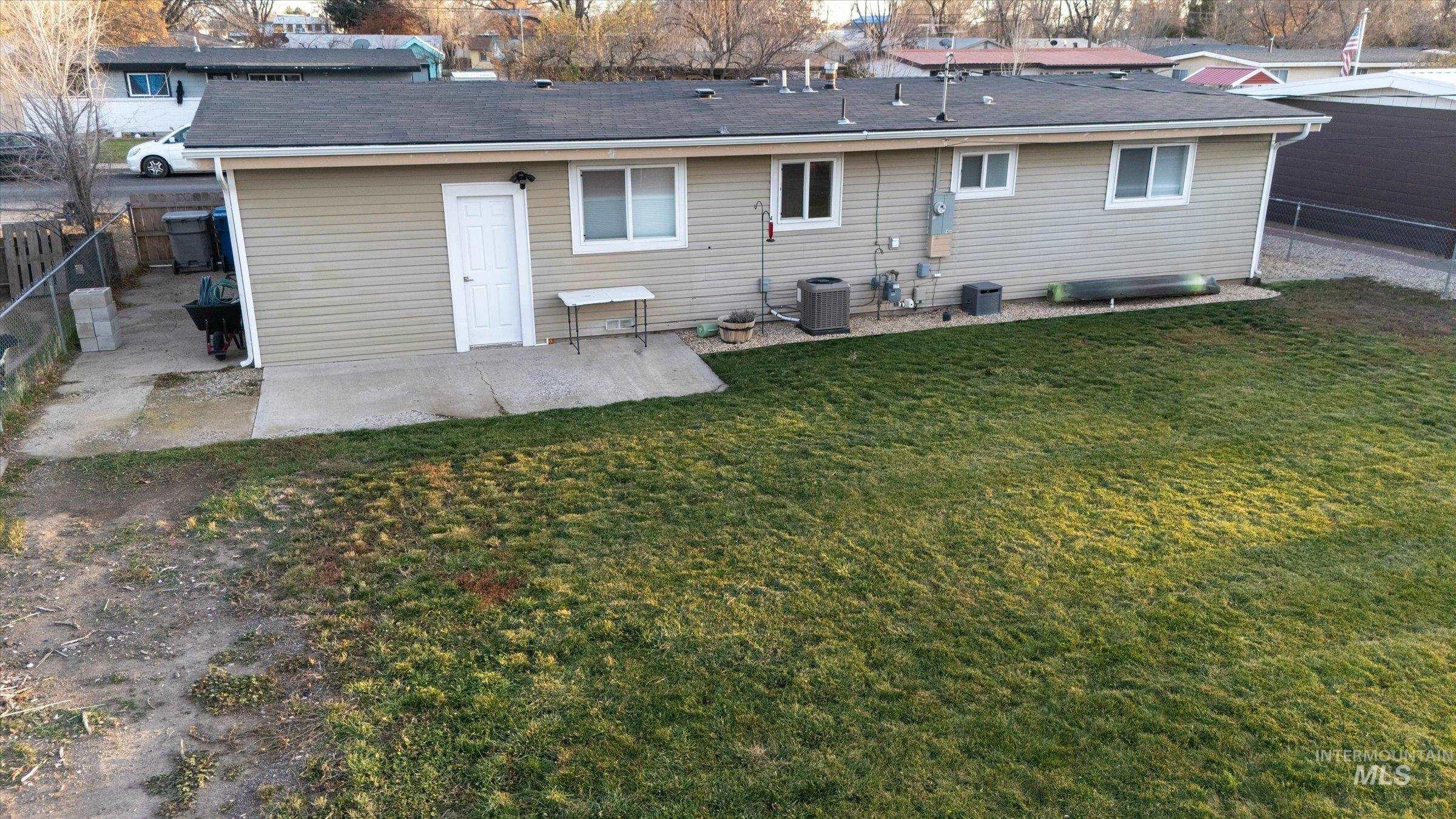 406 Chestnut Street Mountain Home, ID 83647 - Photo 24 of 31 Rear view of house featuring a patio area and a fenced backyard