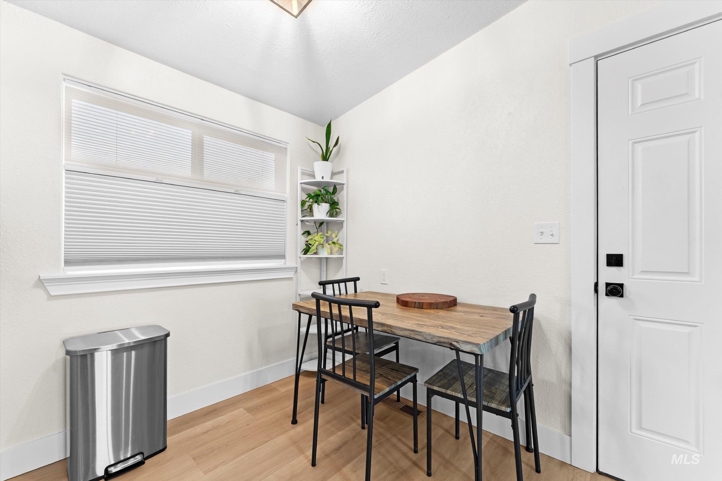406 Chestnut Street Mountain Home, ID 83647 - Photo 6 of 31 Dining room featuring light wood-style floors and baseboards