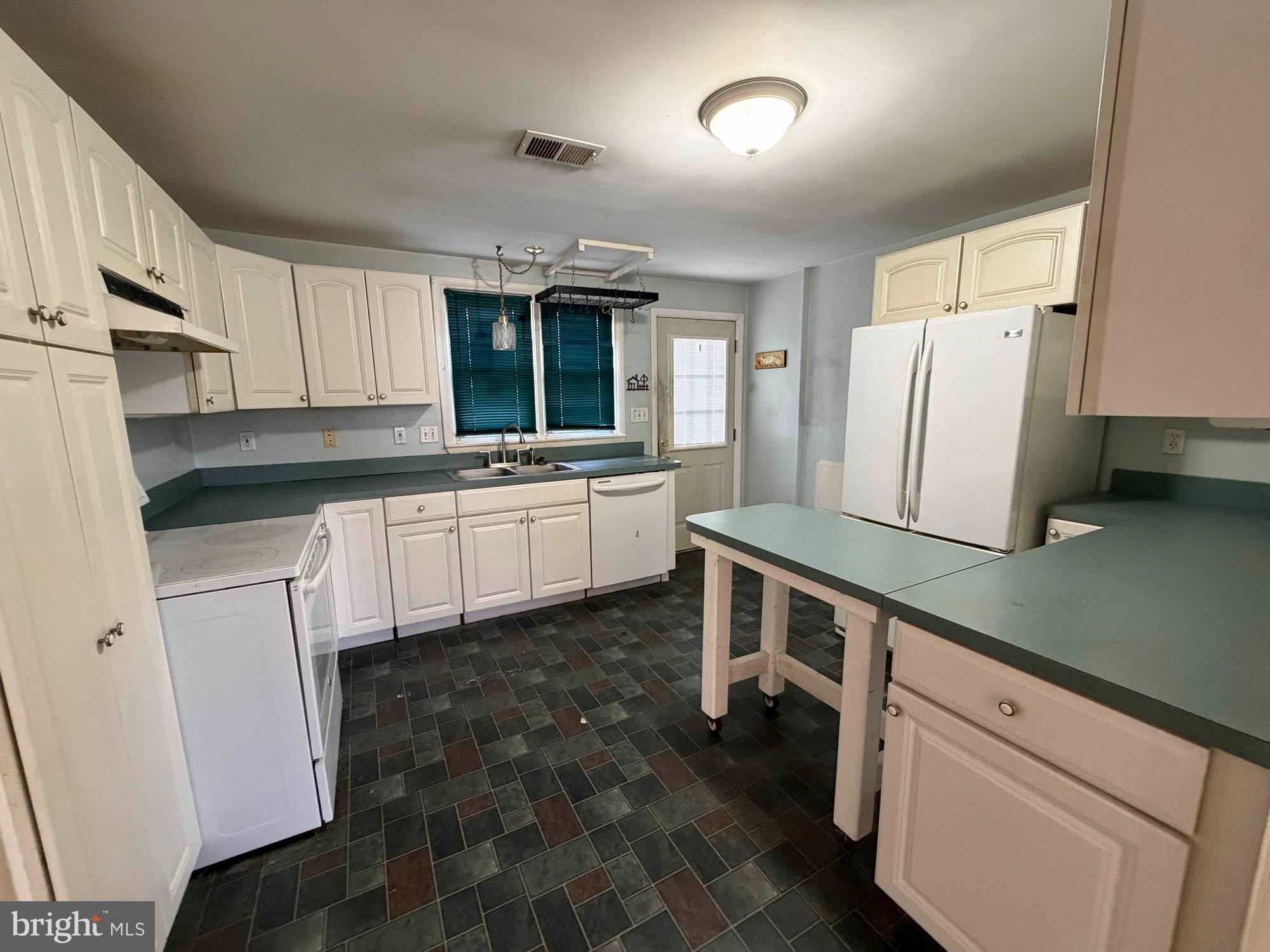 1129 Thompson Avenue Severn, MD 21144 - Photo 14 of 34 a kitchen with granite countertop white cabinets and white appliances