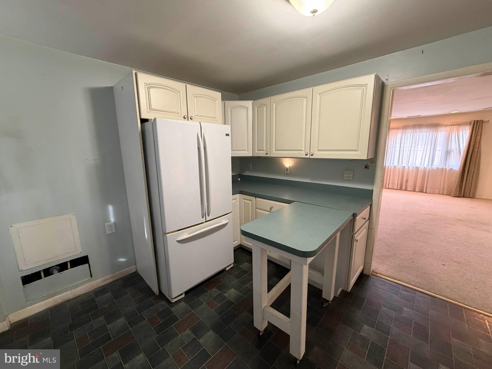 1129 Thompson Avenue Severn, MD 21144 - Photo 16 of 34 a kitchen with a refrigerator and a sink