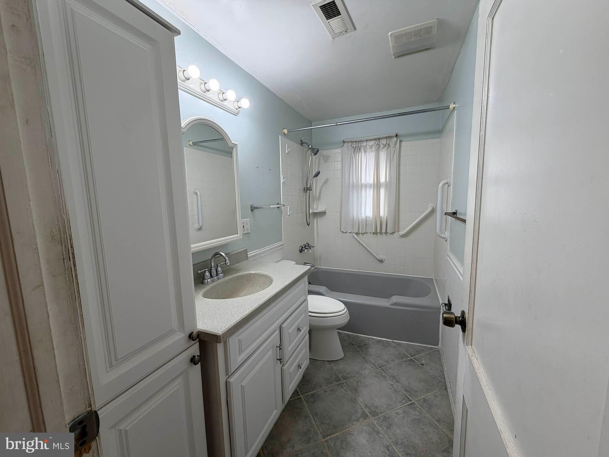 1129 Thompson Avenue Severn, MD 21144 - Photo 23 of 34 a bathroom with a sink a toilet a mirror and vanity