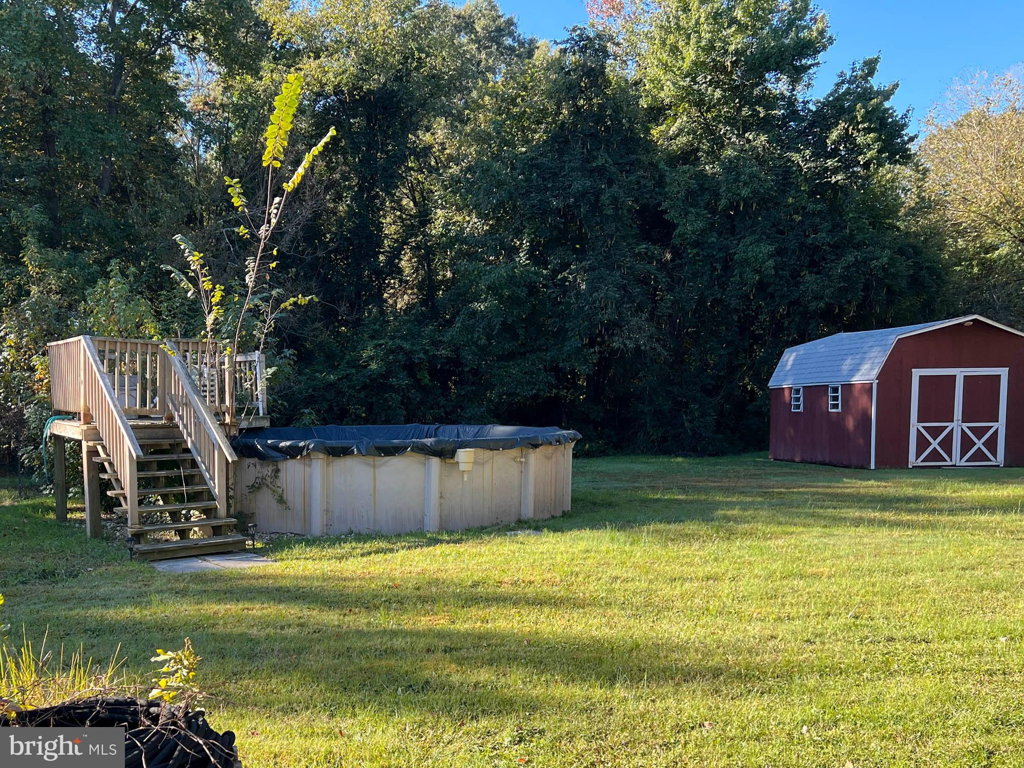 1129 Thompson Avenue Severn, MD 21144 - Photo 7 of 34 a view of a swimming pool with a bench