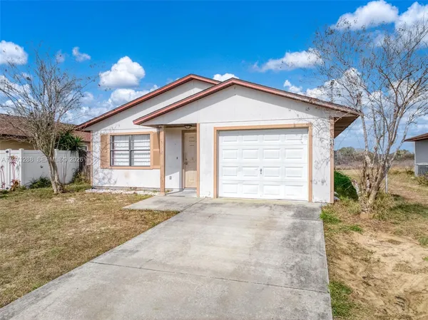 a view of a house with a yard and garage