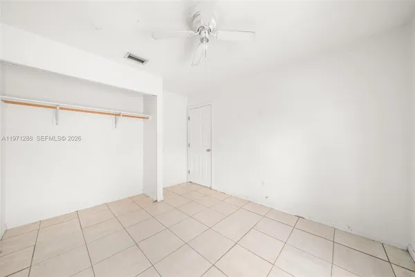 a view of a bedroom with washer and dryer