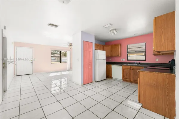 a view of kitchen with granite countertop cabinets