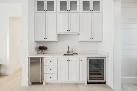 a kitchen with granite countertop white cabinets and stainless steel appliances