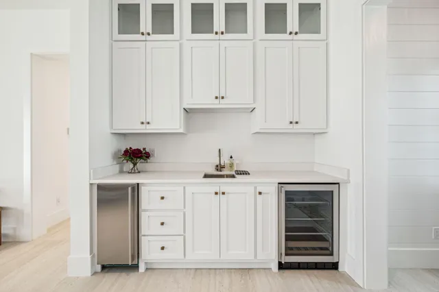 a kitchen with granite countertop white cabinets and stainless steel appliances