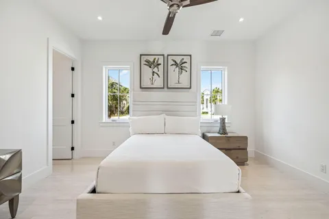 a bedroom with a large bed and paintings on the wall