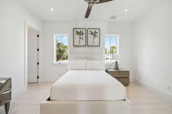 a bedroom with a large bed and paintings on the wall