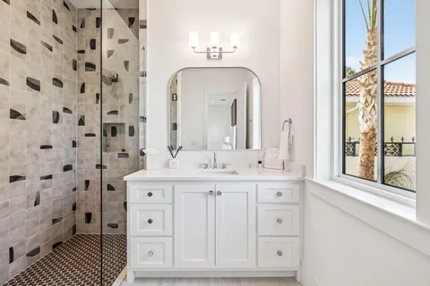 a spacious bathroom with double vanity and a mirror