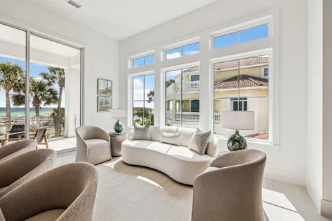a living room with furniture and a potted plant