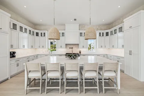 a kitchen with granite countertop cabinets and chairs