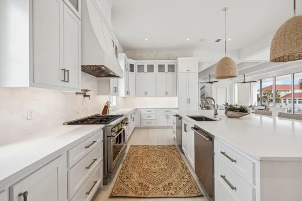 a kitchen with stainless steel appliances granite countertop a sink stove and cabinets