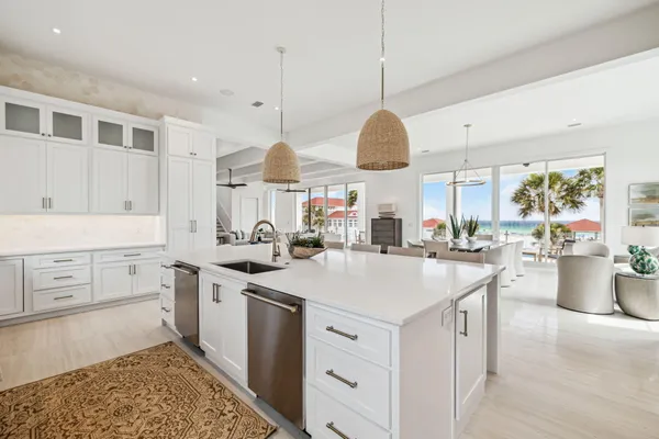 a kitchen with a stove a sink a center island and a window