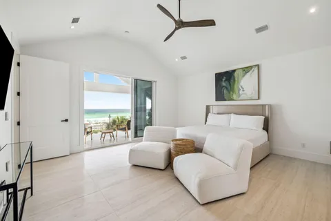 a spacious bedroom with a bed and a large window