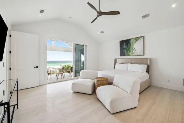 a spacious bedroom with a bed and a large window