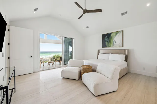 a spacious bedroom with a bed and a large window