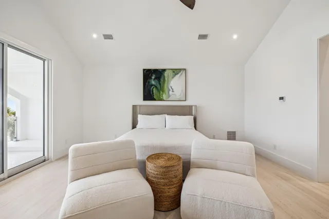 a bedroom with a bed and a painting on the wall