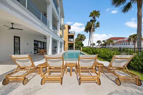 a view of a patio with a table and chairs