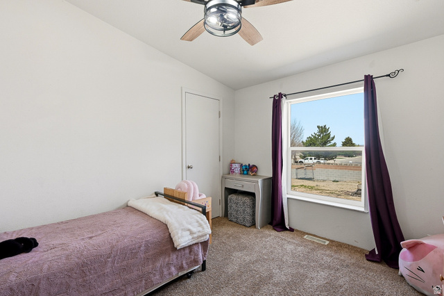 1637 East Midvalley Road Enoch, UT 84721 - Photo 27 of 48 Bedroom featuring vaulted ceiling, light colored carpet, and a ceiling fan