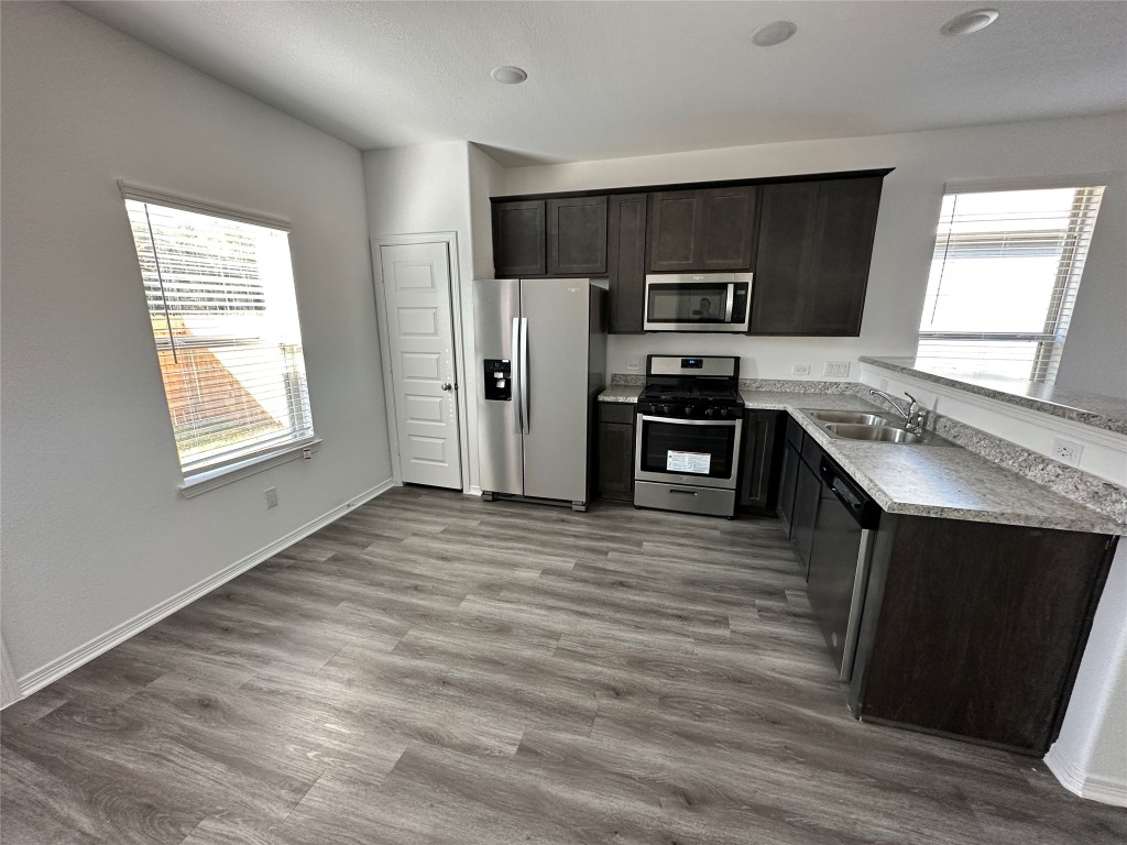 16662 Moss Lane Porter, TX 77365 - Photo 3 of 12 a kitchen with stainless steel appliances a refrigerator stove and sink