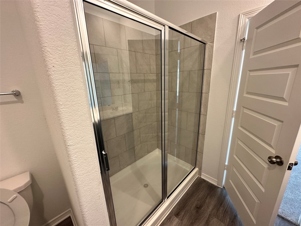 16662 Moss Lane Porter, TX 77365 - Photo 5 of 12 a bathroom with a glass door shower and toilet