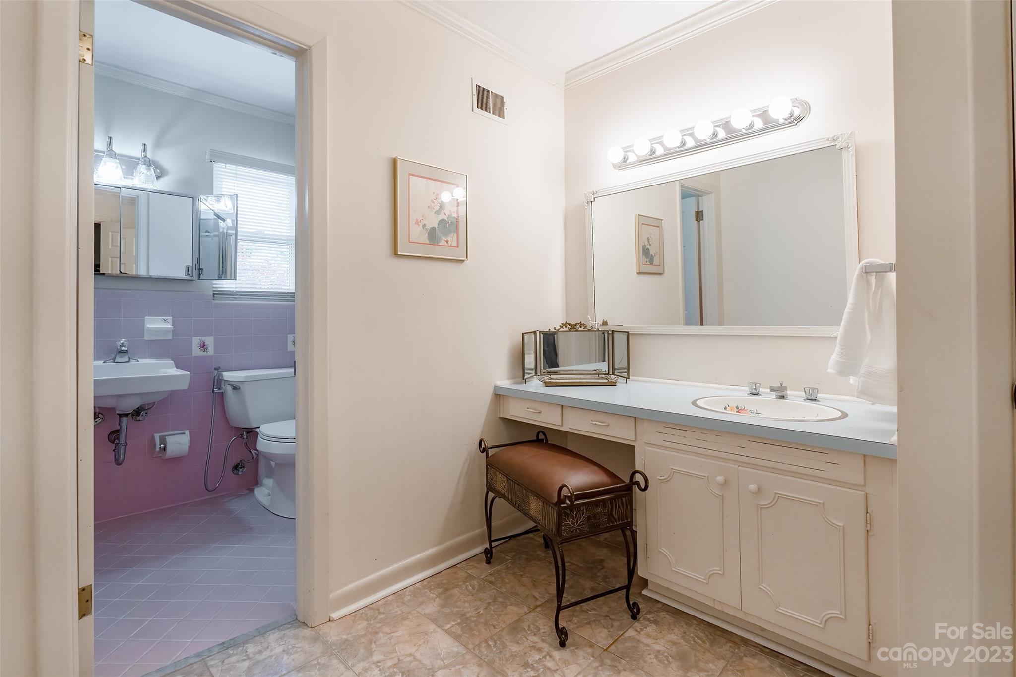 6916 Thermal Road Charlotte, NC 28211 - Photo 16 of 47 a bathroom with a sink a toilet a light fixture and mirror